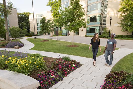 Students walk through the Oaks Circle, on the residential side of campus.